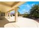 Expansive backyard with covered patio, lush landscaping, and mountain views at 8236 Imperial Lakes St, Las Vegas, NV 89131