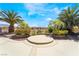 Backyard with a circular patio area, desert landscaping, and mountain views at 8236 Imperial Lakes St, Las Vegas, NV 89131