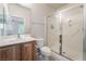 Bathroom featuring a single sink vanity, toilet, and standing shower with glass doors at 8236 Imperial Lakes St, Las Vegas, NV 89131