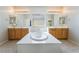 Bright bathroom featuring a soaking tub with separate vanities and abundant counter space at 8236 Imperial Lakes St, Las Vegas, NV 89131