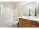 Well-lit bathroom with a shower-tub combo, updated vanity, and modern fixtures at 8236 Imperial Lakes St, Las Vegas, NV 89131