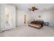 Spacious bedroom features neutral colors, ceiling fan, and ensuite bathroom access at 8236 Imperial Lakes St, Las Vegas, NV 89131