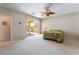 Spacious bedroom with neutral carpet, ceiling fan, and sliding glass door to a patio at 8236 Imperial Lakes St, Las Vegas, NV 89131
