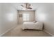 Cozy bedroom with neutral walls, carpet flooring, and a decorative ceiling fan at 8236 Imperial Lakes St, Las Vegas, NV 89131