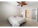 Bedroom with carpet flooring, decorative ceiling fan, and double doors to hallway at 8236 Imperial Lakes St, Las Vegas, NV 89131
