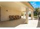 Covered patio with four chairs, and spacious seating with a manicured backyard at 8236 Imperial Lakes St, Las Vegas, NV 89131