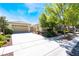 Welcoming single-story home boasting a two-car garage, neutral exterior, and green landscaping at 8236 Imperial Lakes St, Las Vegas, NV 89131