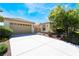 Inviting single-story home with attached two car garage, neutral color palette, and well manicured landscaping at 8236 Imperial Lakes St, Las Vegas, NV 89131