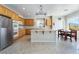 Bright kitchen featuring wood cabinets, stainless steel appliances, and an island with seating at 8236 Imperial Lakes St, Las Vegas, NV 89131
