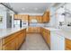 Bright kitchen with wood cabinetry, tile floors, stainless steel appliances, and a large island at 8236 Imperial Lakes St, Las Vegas, NV 89131