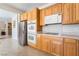 Close-up of the kitchen featuring stainless steel appliances, and wood cabinets at 8236 Imperial Lakes St, Las Vegas, NV 89131