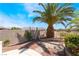 Backyard area with mature landscaping including palm trees and stone accents at 8236 Imperial Lakes St, Las Vegas, NV 89131