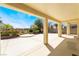 Covered patio area with mature tropical landscaping perfect for outdoor living at 8236 Imperial Lakes St, Las Vegas, NV 89131