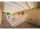 Relaxing covered patio with brick flooring, fountain, and elegant outdoor furniture at 8236 Imperial Lakes St, Las Vegas, NV 89131
