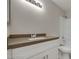 Updated bathroom features a sleek vanity with white cabinets, modern fixtures and updated countertop at 8804 River Pines Ct # 202, Las Vegas, NV 89117