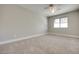 Bedroom features a ceiling fan, plush carpet, neutral walls and natural light from a window at 8804 River Pines Ct # 202, Las Vegas, NV 89117
