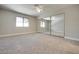 Spacious bedroom features mirrored closet doors, ceiling fan, and natural light from a window at 8804 River Pines Ct # 202, Las Vegas, NV 89117