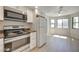 Modern kitchen featuring stainless steel appliances, bright white cabinets, and dining nook area at 8804 River Pines Ct # 202, Las Vegas, NV 89117