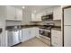 Stylish kitchen featuring stainless steel appliances, white cabinets, and updated countertops at 8804 River Pines Ct # 202, Las Vegas, NV 89117