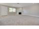 Spacious carpeted living room with natural light, featuring a fireplace and recessed lighting at 8804 River Pines Ct # 202, Las Vegas, NV 89117