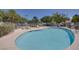 Community pool features lounge chairs, picnic tables, and lush landscaping for a relaxing experience at 8804 River Pines Ct # 202, Las Vegas, NV 89117