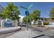 Entrance to the community features decorative signage with lush landscaping, and a street sign at 8804 River Pines Ct # 202, Las Vegas, NV 89117