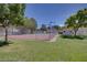 Tennis court in a well-maintained community with fencing and lush green surroundings at 8804 River Pines Ct # 202, Las Vegas, NV 89117