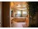 A bathroom featuring a large garden tub, dual sinks, tile floors, high ceilings and walk-in closet entry at 9905 Fox Springs Dr, Las Vegas, NV 89117