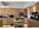 Well-equipped kitchen boasts modern appliances, wooden cabinetry, and granite countertops, perfect for cooking at 9905 Fox Springs Dr, Las Vegas, NV 89117