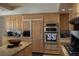 Gourmet kitchen with built-in appliances, custom cabinets, and a center island, designed for culinary enthusiasts at 9905 Fox Springs Dr, Las Vegas, NV 89117