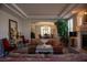 Sophisticated living room with comfortable seating, a fireplace, and an open floor plan leading to the dining area at 9905 Fox Springs Dr, Las Vegas, NV 89117
