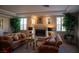 Cozy living room features a fireplace, plush sofas, and large potted plants for a comfortable and inviting atmosphere at 9905 Fox Springs Dr, Las Vegas, NV 89117