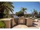 This outdoor kitchen features stainless steel appliances, a grill, and ample counter space perfect for entertaining at 9905 Fox Springs Dr, Las Vegas, NV 89117