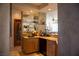 Elegant wet bar area with granite countertops, cabinetry, and mirrored backsplash at 9905 Fox Springs Dr, Las Vegas, NV 89117