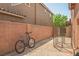 Spacious backyard area featuring brick-paved ground, a fenced dog run, and plenty of room for outdoor activities and storage at 10030 Trotter Peak St, Las Vegas, NV 89178