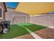 Backyard featuring artificial grass, shade structure and a white soccer goal, great for relaxation, recreation and entertaining at 10030 Trotter Peak St, Las Vegas, NV 89178