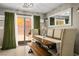 Dining area with a rustic wood table, bench seating, and stylish curtains at 10030 Trotter Peak St, Las Vegas, NV 89178