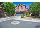 Charming two-story home featuring a blue garage door, stucco exterior, and well-maintained landscaping at 10030 Trotter Peak St, Las Vegas, NV 89178