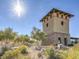 Unique community tower featuring stone and stucco architecture with terracotta tile roof, nestled in a desert landscape at 10030 Trotter Peak St, Las Vegas, NV 89178