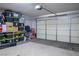 Spacious garage with ample storage, a garage door and room for multiple cars, offering convenience and organization at 10030 Trotter Peak St, Las Vegas, NV 89178