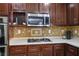 Kitchen with stainless steel appliances, tile backsplash, and abundant cabinetry at 10030 Trotter Peak St, Las Vegas, NV 89178