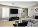 Bright living room with hardwood floors, plantation shutters, and a large sectional sofa at 10030 Trotter Peak St, Las Vegas, NV 89178