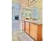 Bathroom view showcasing wood cabinets and view into the living area at 10680 Sapphire Vista Ave, Las Vegas, NV 89144