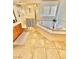 Bright bathroom including tub, shower, and sink with wooden cabinets at 10680 Sapphire Vista Ave, Las Vegas, NV 89144