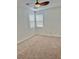 Bright bedroom featuring neutral carpet, dual windows and a ceiling fan at 10680 Sapphire Vista Ave, Las Vegas, NV 89144