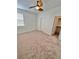 Bedroom with carpeted floor, ceiling fan, large window, and closet at 10680 Sapphire Vista Ave, Las Vegas, NV 89144