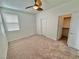 Bedroom with carpeted floor, ceiling fan, large window, and closet at 10680 Sapphire Vista Ave, Las Vegas, NV 89144