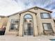 Spacious home exterior showcasing multiple windows, covered patio, and outdoor seating perfect for entertaining at 10680 Sapphire Vista Ave, Las Vegas, NV 89144