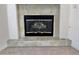 Cozy fireplace with tiled surround and hearth in a carpeted living room at 10680 Sapphire Vista Ave, Las Vegas, NV 89144