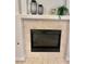 Close up of fireplace with tile surround and a mantel at 10680 Sapphire Vista Ave, Las Vegas, NV 89144